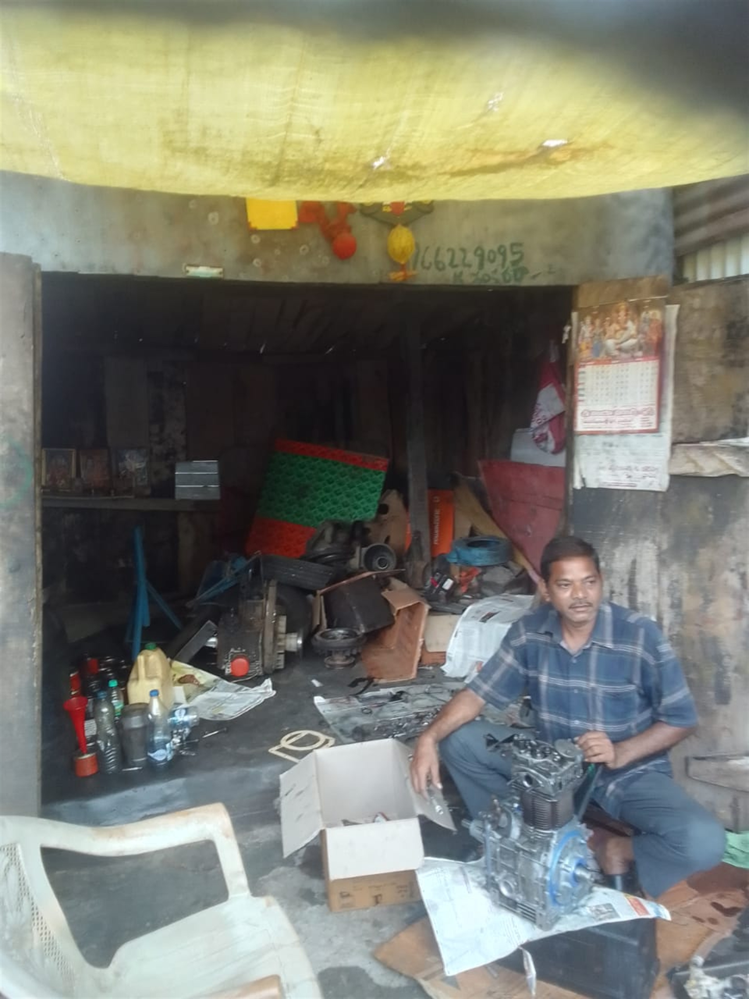 Kanchuparthi Shankarrao at work in his 3-wheeler workshop